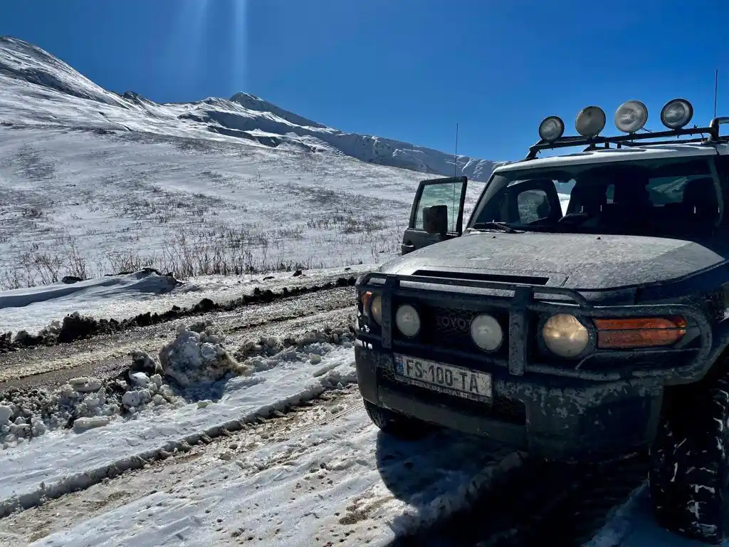 FSTA 4x4 rental car on a snowy mountain road