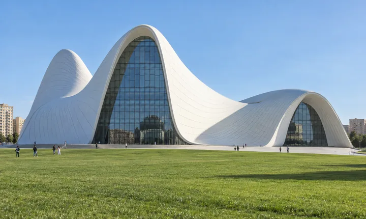 The white curved Heydar Aliyev Center above a green lawn in Baku The white curved Heydar Aliyev Center above a green lawn in Baku