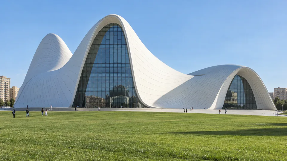 The white curved Heydar Aliyev Center above a green lawn in Baku