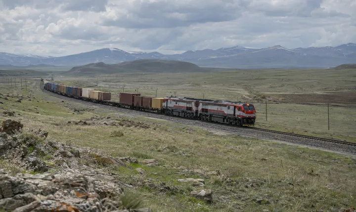 A freight train crossing an open high plateau railway corridor A freight train crossing an open high plateau railway corridor