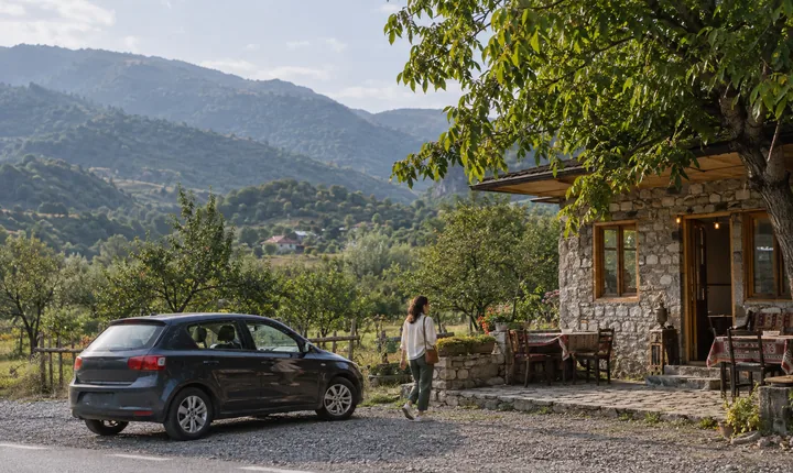 A parked car beside a roadside tea house in wooded Azerbaijani foothills A parked car beside a roadside tea house in wooded Azerbaijani foothills