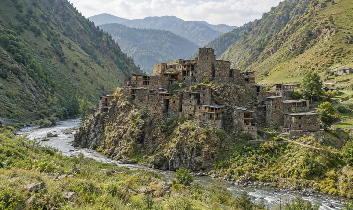 Stone towers of Shatili fortress village beside a river in the green Caucasus mountains Stone towers of Shatili fortress village beside a river in the green Caucasus mountains
