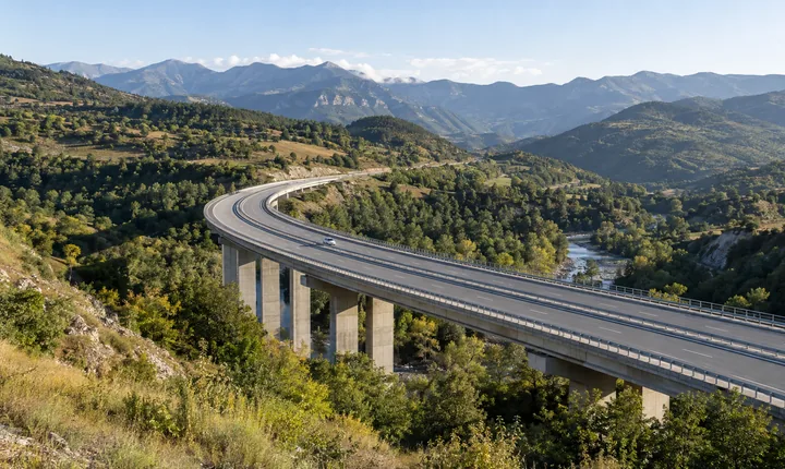 A divided highway curves across a viaduct through Georgia's green foothills A divided highway curves across a viaduct through Georgia's green foothills
