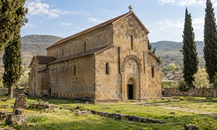 Bolnisi Sioni's golden stone basilica in a quiet grassy courtyard in Kvemo Kartli Bolnisi Sioni's golden stone basilica in a quiet grassy courtyard in Kvemo Kartli