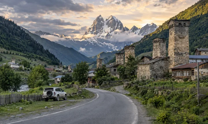 A paved road approaches Mestia's stone towers beneath the peaks of Svaneti A paved road approaches Mestia's stone towers beneath the peaks of Svaneti