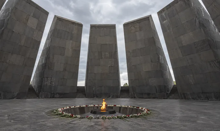 Eternal flame and flowers inside the circle of basalt slabs at Tsitsernakaberd in Yerevan Eternal flame and flowers inside the circle of basalt slabs at Tsitsernakaberd in Yerevan