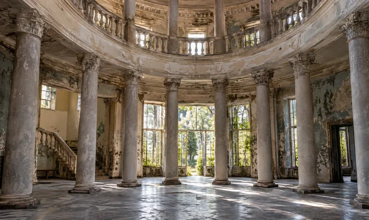 Sunlight falls across weathered columns and tiled floors in a Tskaltubo sanatorium hall Sunlight falls across weathered columns and tiled floors in a Tskaltubo sanatorium hall
