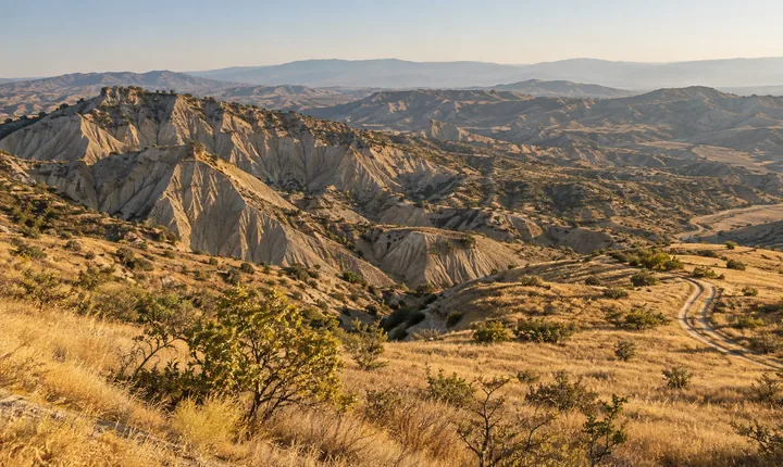 Eroded clay badlands and golden steppe in Georgia's Vashlovani Protected Areas Eroded clay badlands and golden steppe in Georgia's Vashlovani Protected Areas